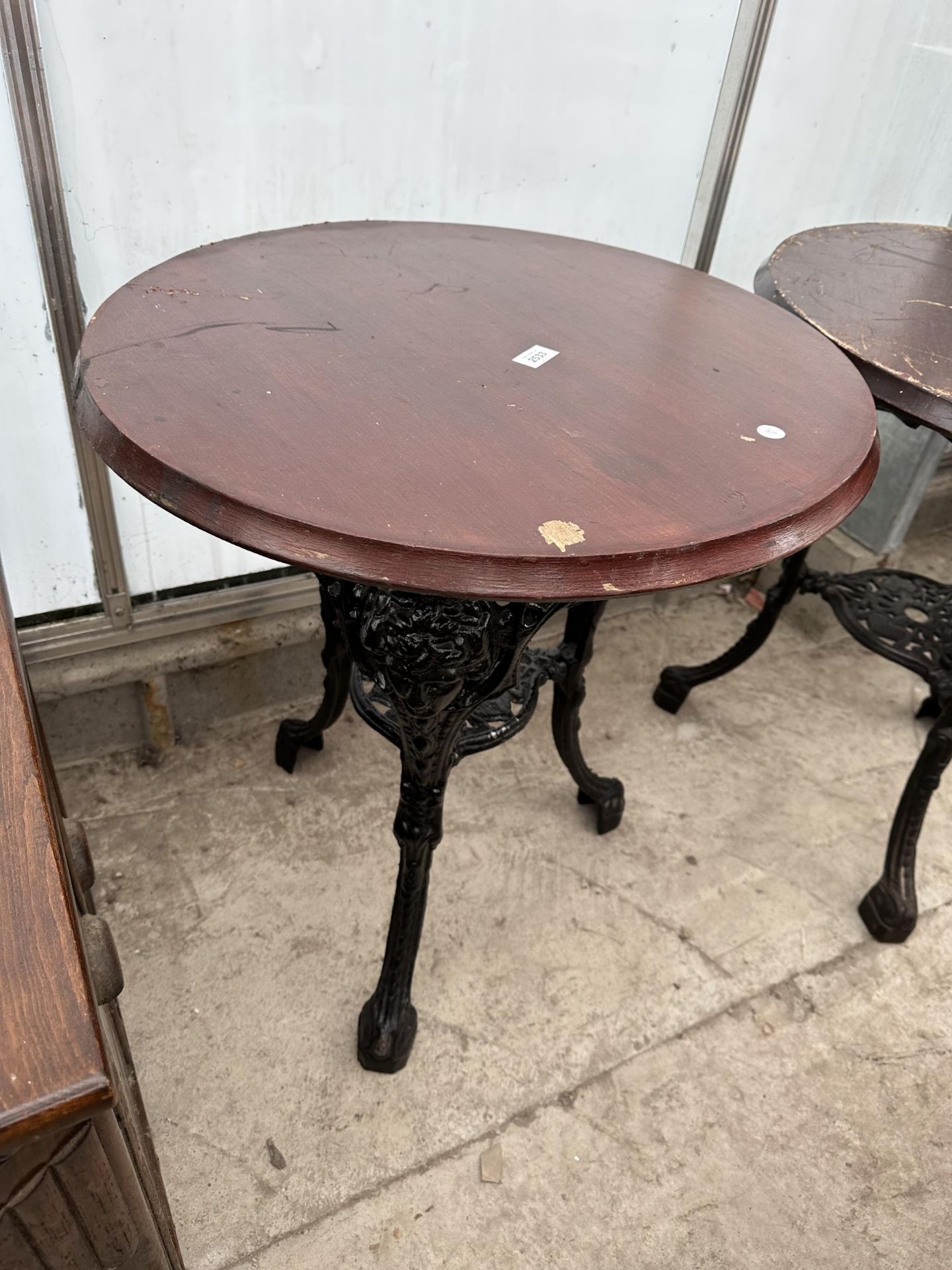 A 24.5" DIAMETER PUB TABLE ON A HEAVY CAST IRON BASE