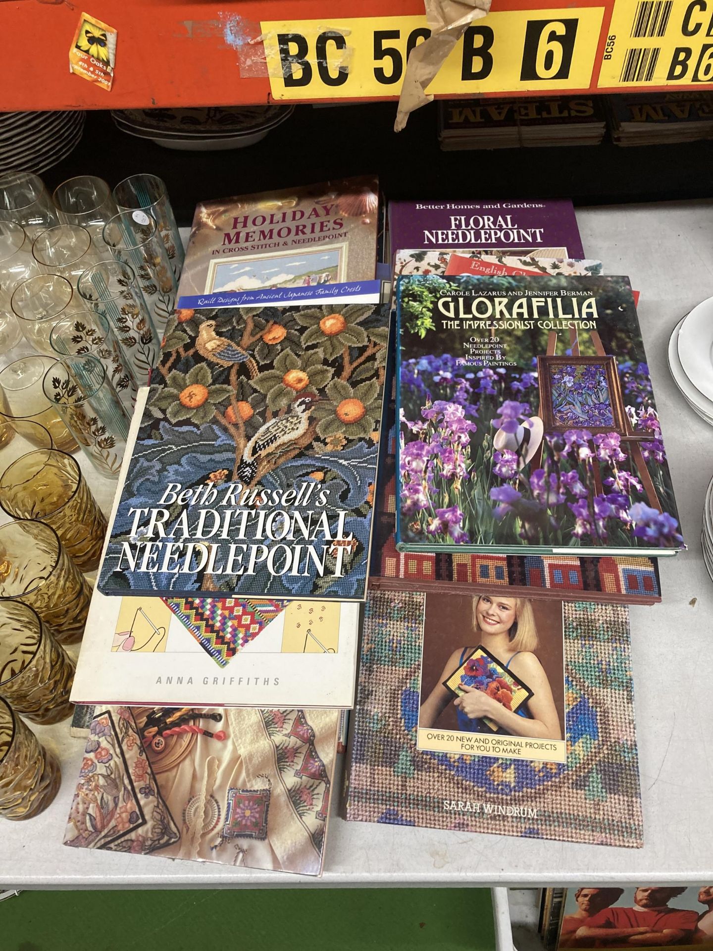 A LARGE QUANTITY OF NEEDLEPOINT AND EMBROIDERY BOOKS