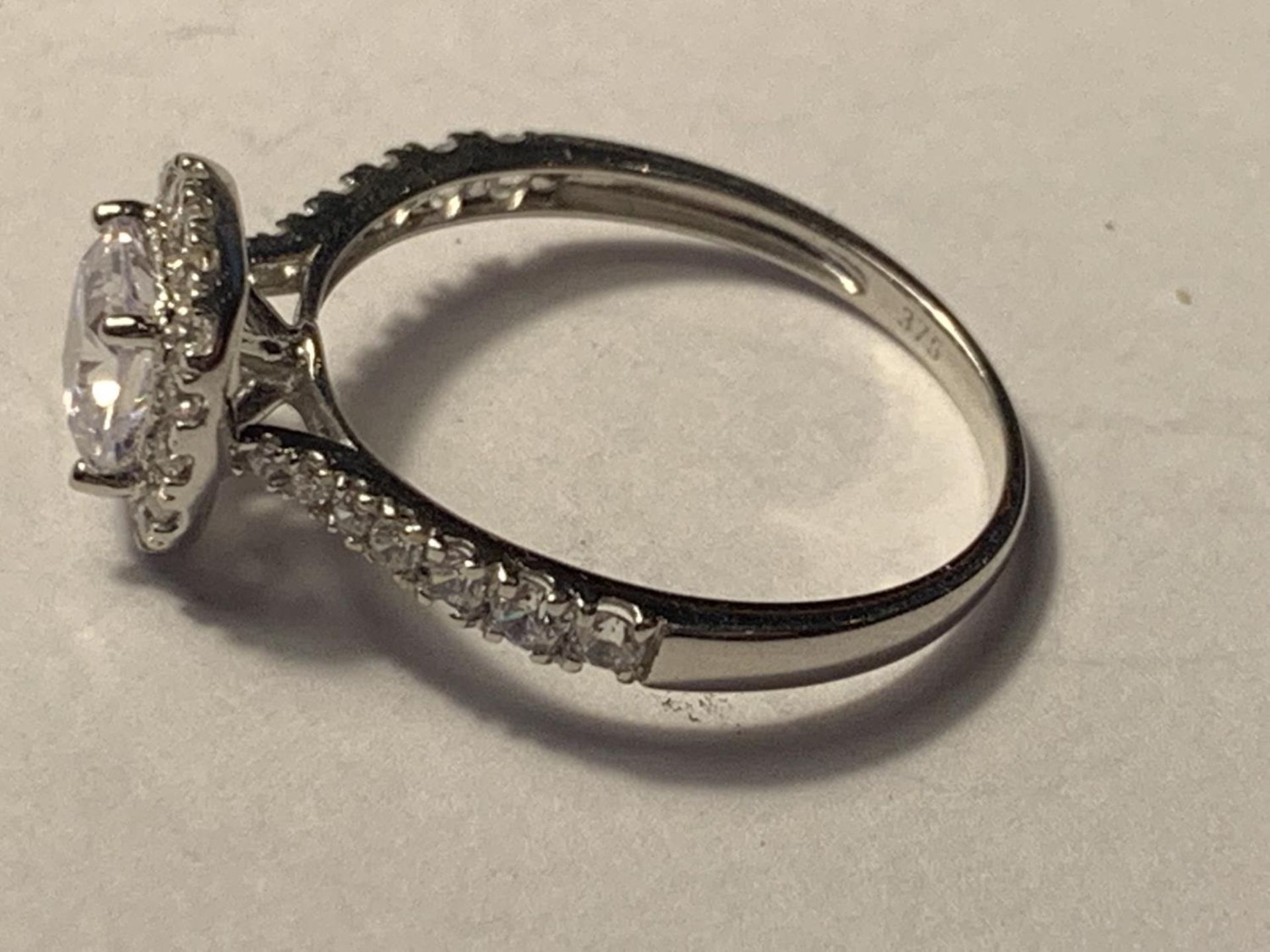 A 9 CARAT WHITE GOLD RING WITH A LARGE SQUARE CUBIC ZIRCONIA ALSO SURROUNDED AND ON THE SHOULDERS - Image 2 of 3