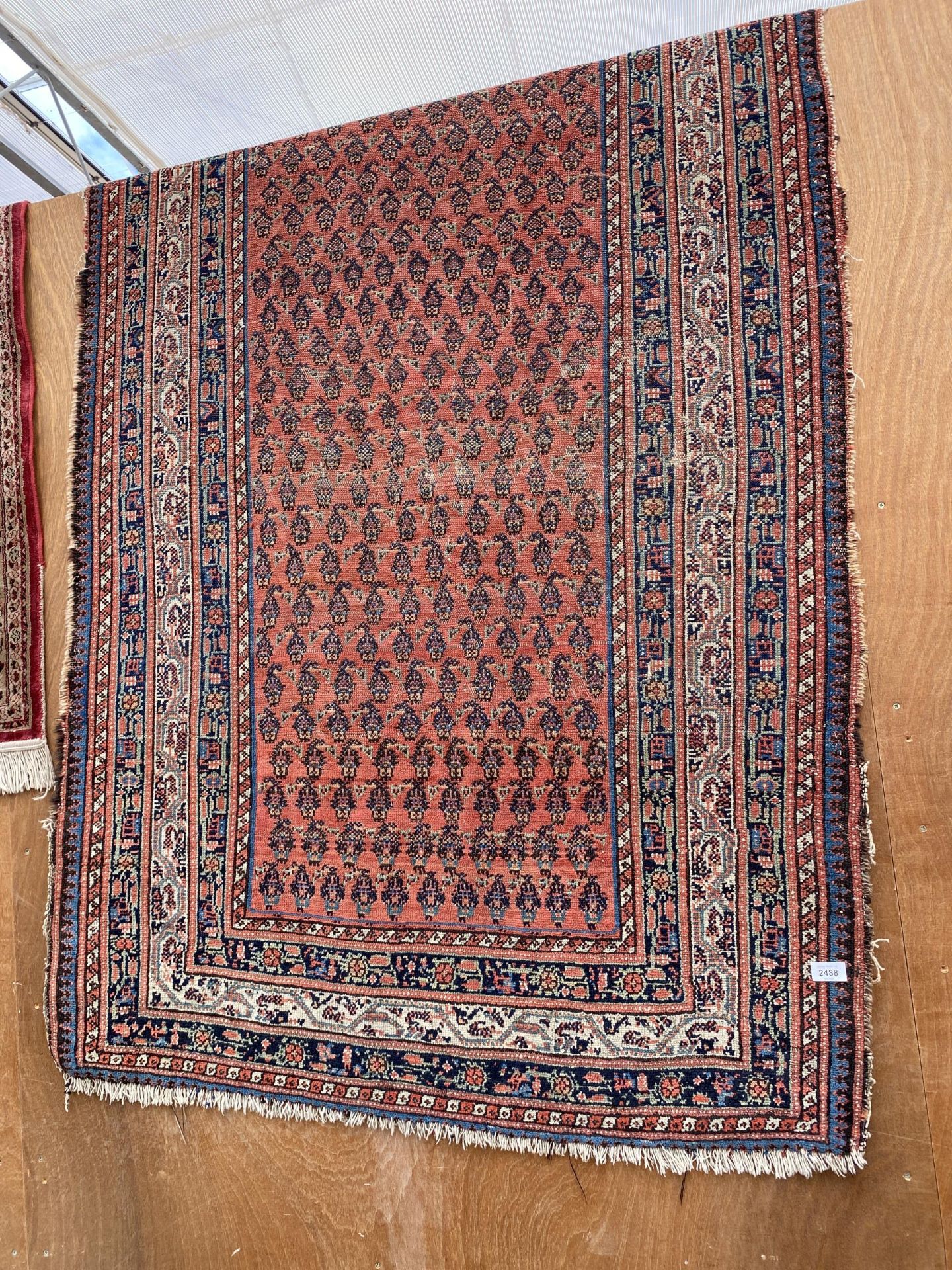 A LARGE RED AND BLUE PATTERNED RUG