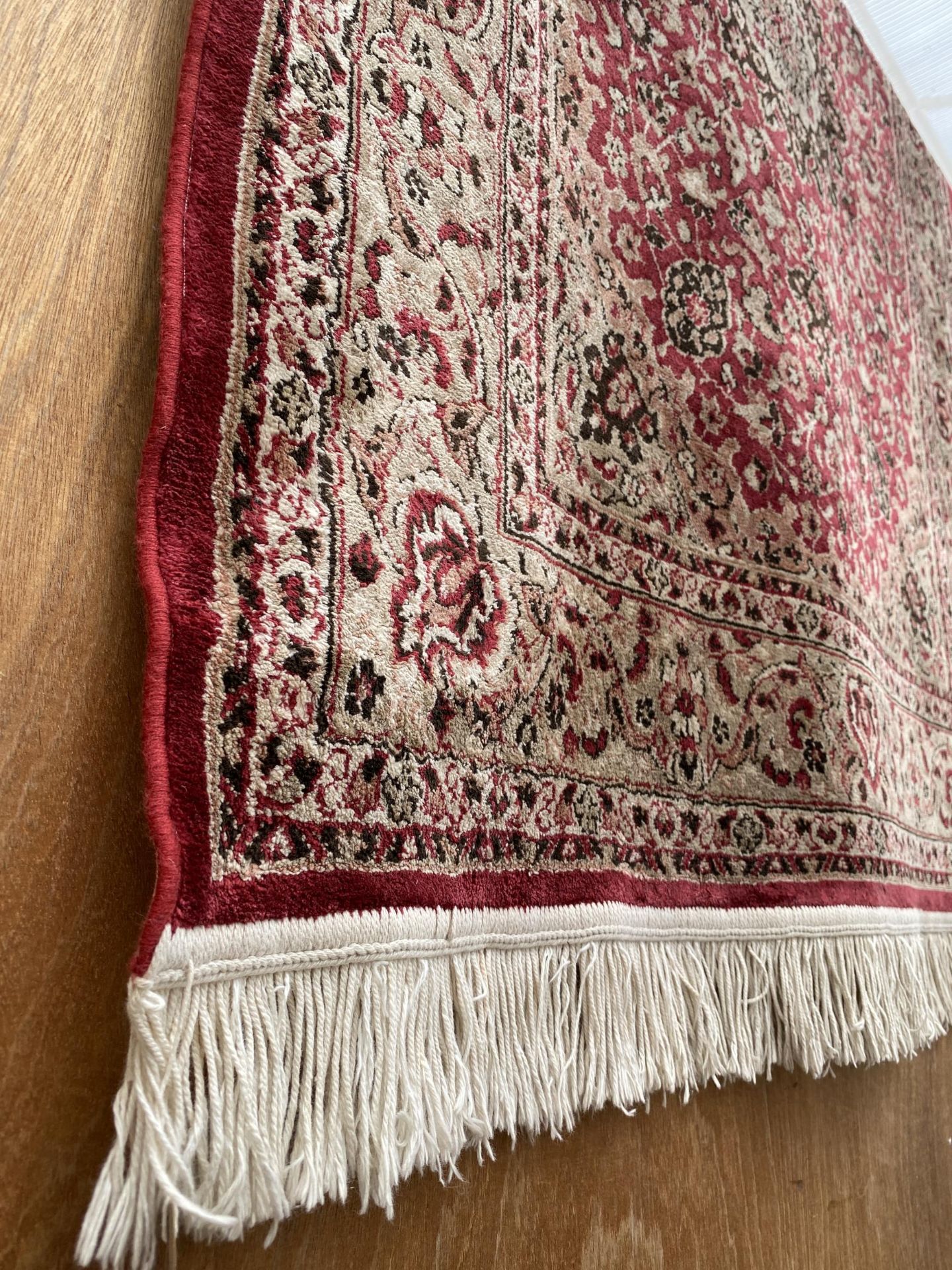 A RED PATTERNED FRINGED RUG - Image 2 of 2