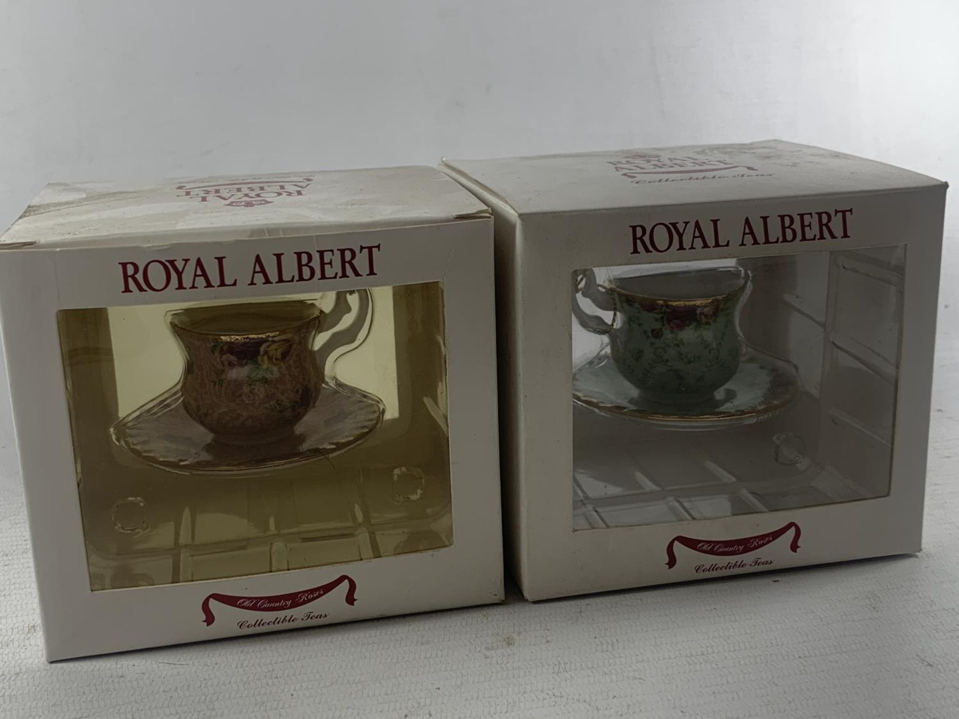 TWO ROYAL ALBERT BOXED MINATURE TEACUP AND SAUCER ORNAMENTS - DUSKY PINK AND PEPPERMINT