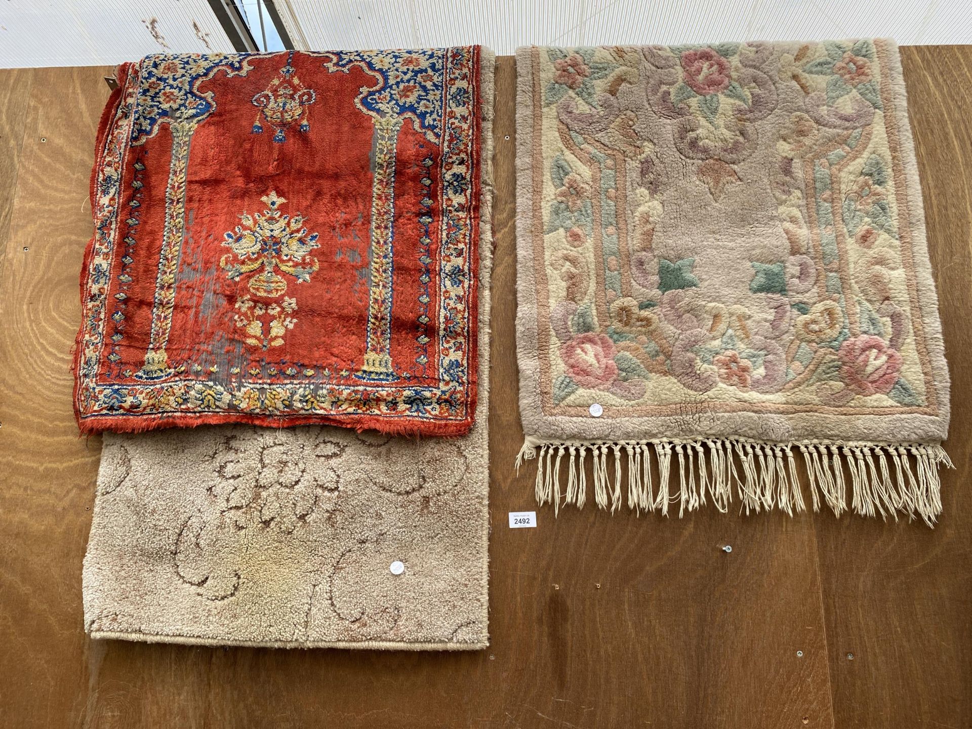 THREE SMALL PATTERNED RUGS