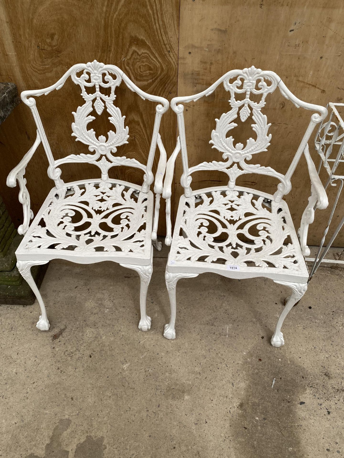 A PAIR OF WHITE CAST ALLOY BISTRO CARVER CHAIRS