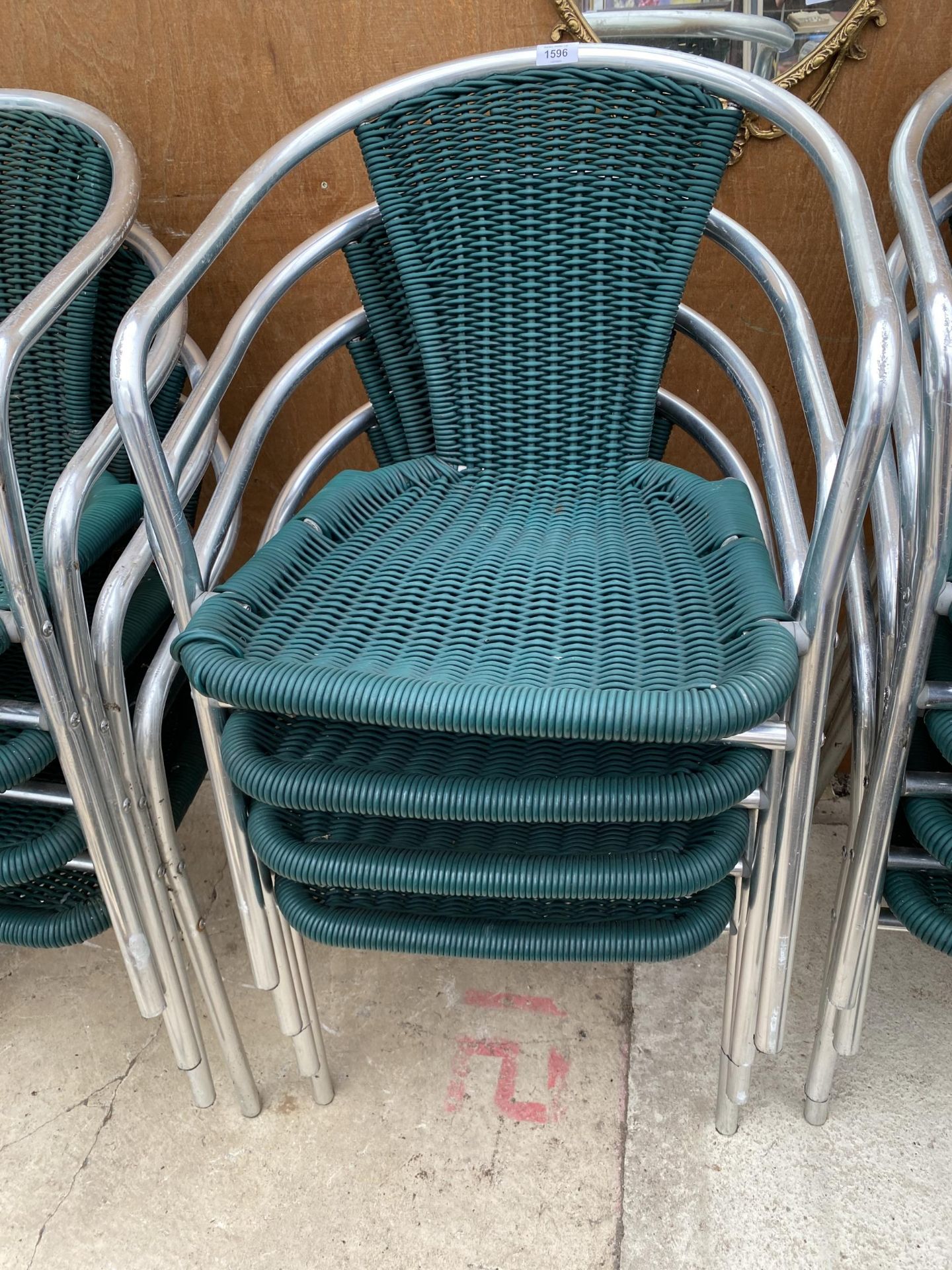 FOUR CHROME AND RATTAN BISTRO STACKING CHAIRS