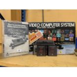 AN ATARI VIDEO COMPUTER SYSTEM, BOXED WITH INSTRUCTIONS AND GAMES