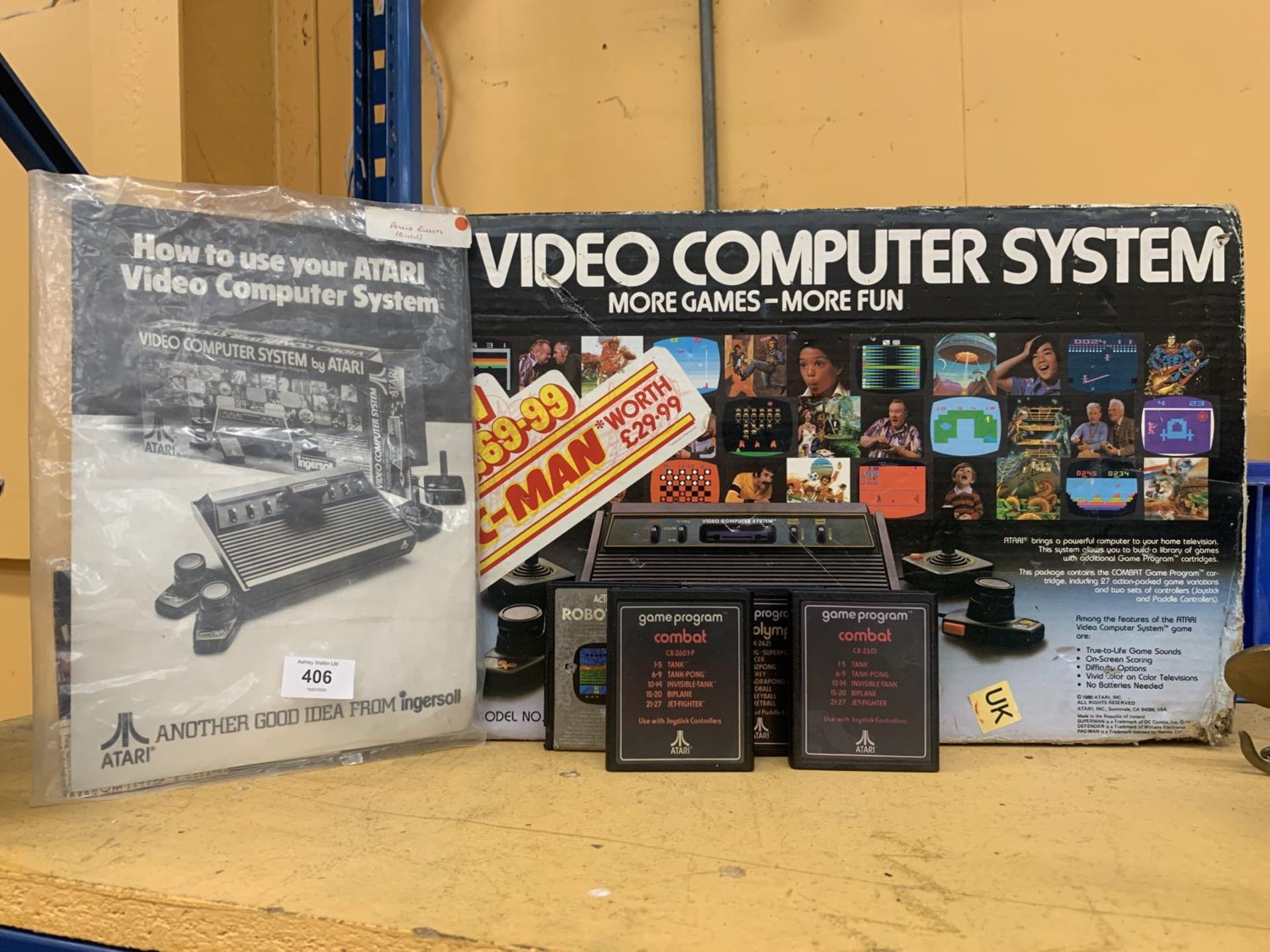 AN ATARI VIDEO COMPUTER SYSTEM, BOXED WITH INSTRUCTIONS AND GAMES