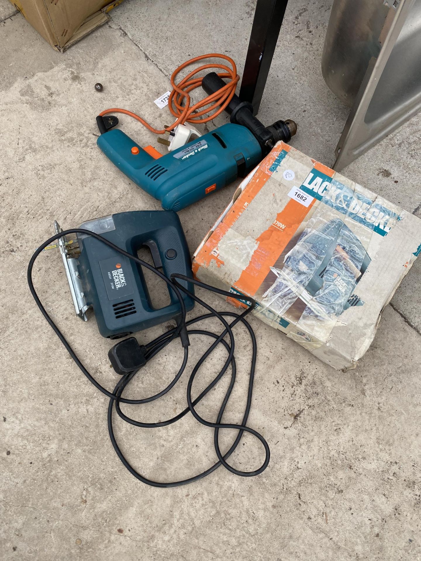 A BLACK AND DECKER ELECTRIC DRILL AND A BLACK AND DECK JIGSAW