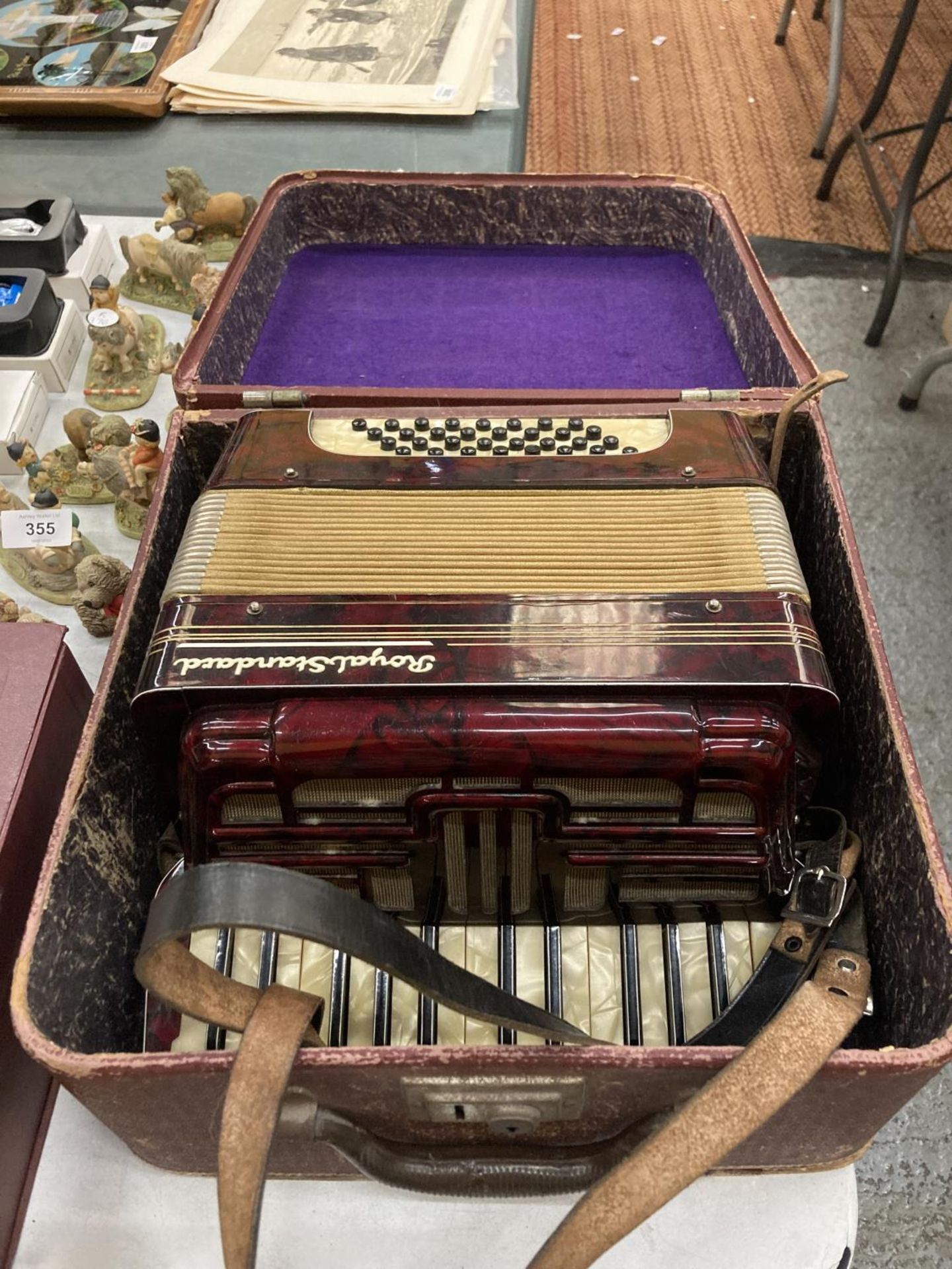 A VINTAGE ROYAL STANDARD ACCORDIAN WITH RED BAKELITE BODY IN THE ORIGINAL CASE