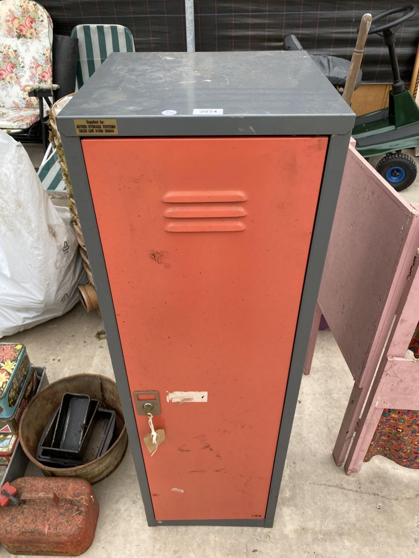 A METAL SINGLE DOOR CABINET WITH KEY