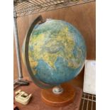 A VINTAGE WORLD GLOBE WITH A WOODEN BASE