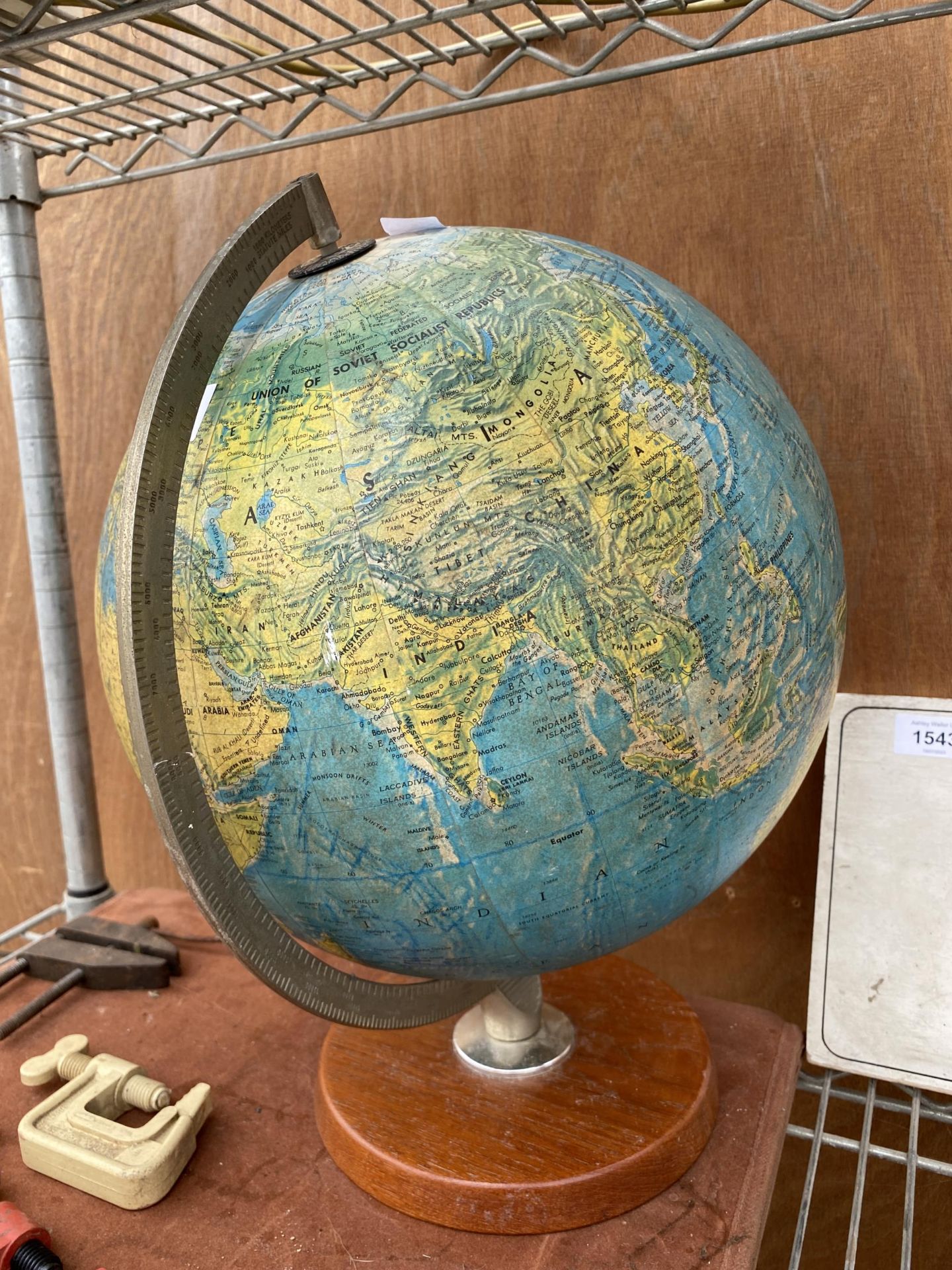 A VINTAGE WORLD GLOBE WITH A WOODEN BASE