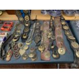 A LARGE COLLECTION OF HORSE BRASSES ON MARTINGALES