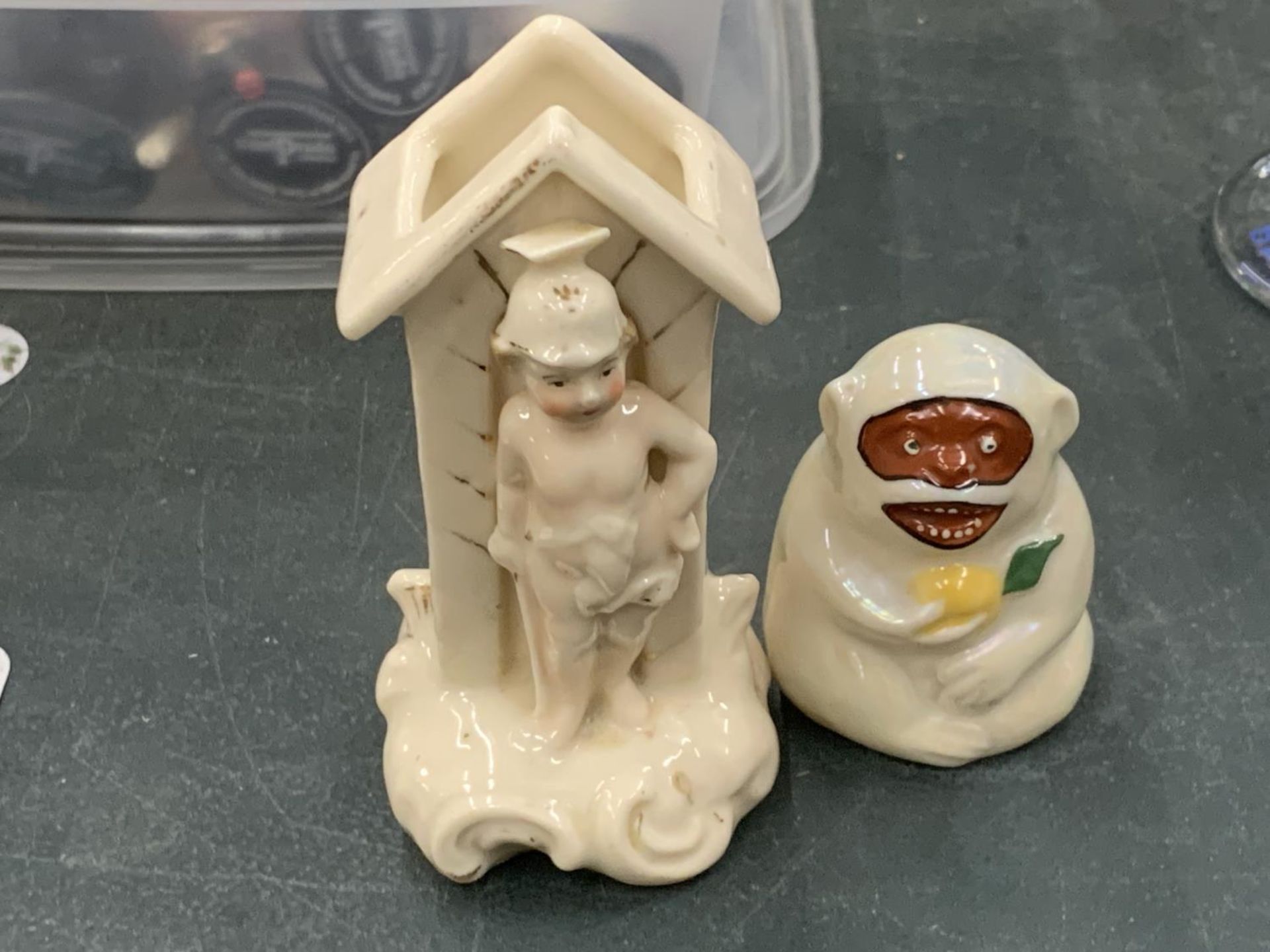 A VINTAGE GERMAN SENTRY BOX SPILL HOLDER AND A CARLTON CRESTED WARE MONKEY