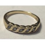 A 9 CARAT GOLD RING WITH FIVE IN LINE DIAMONDS SIZE N