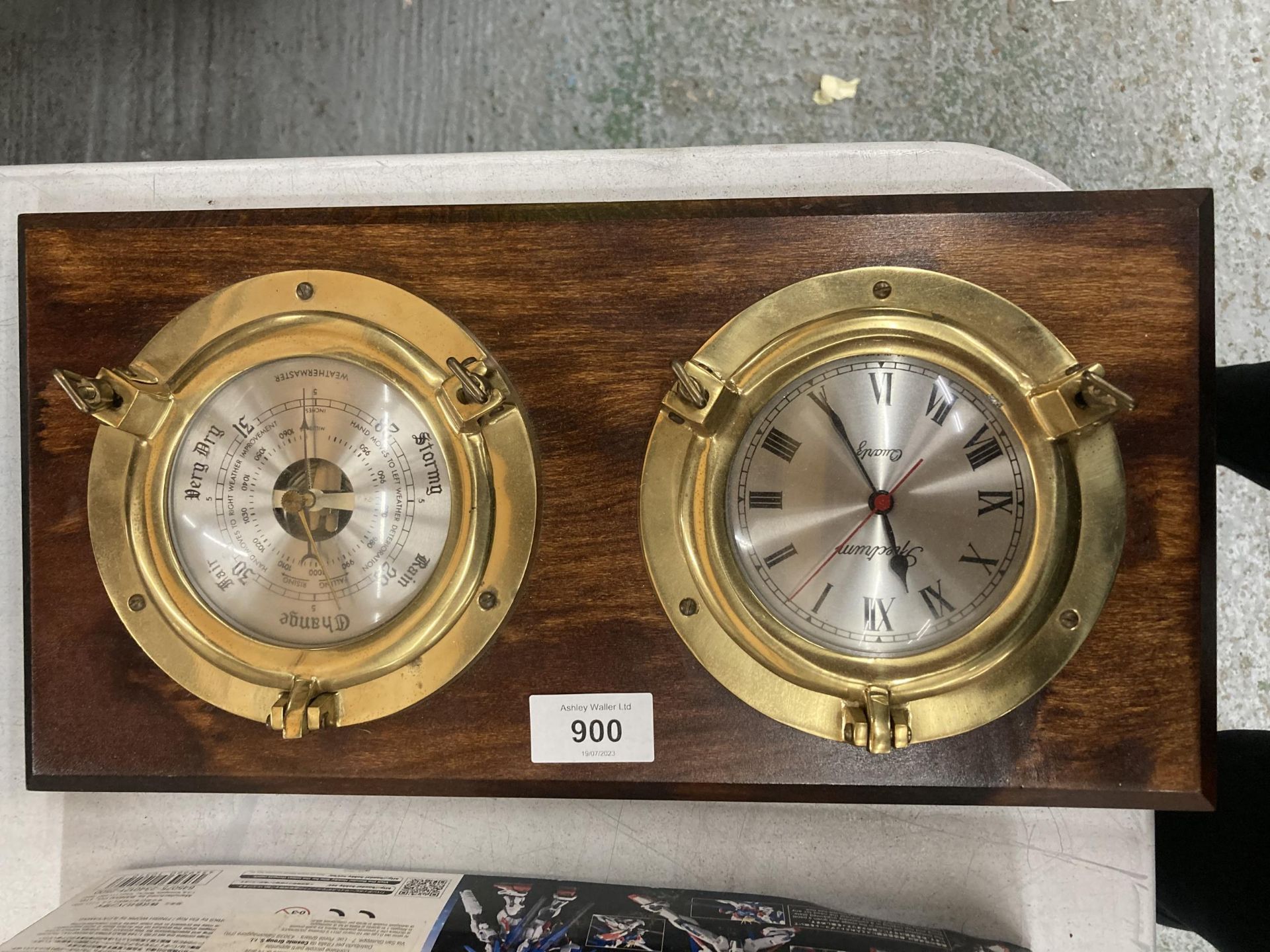 A MAHOGANY FRAMED BRASS PORTHOLE STYLE CLOCK AND BAROMETER