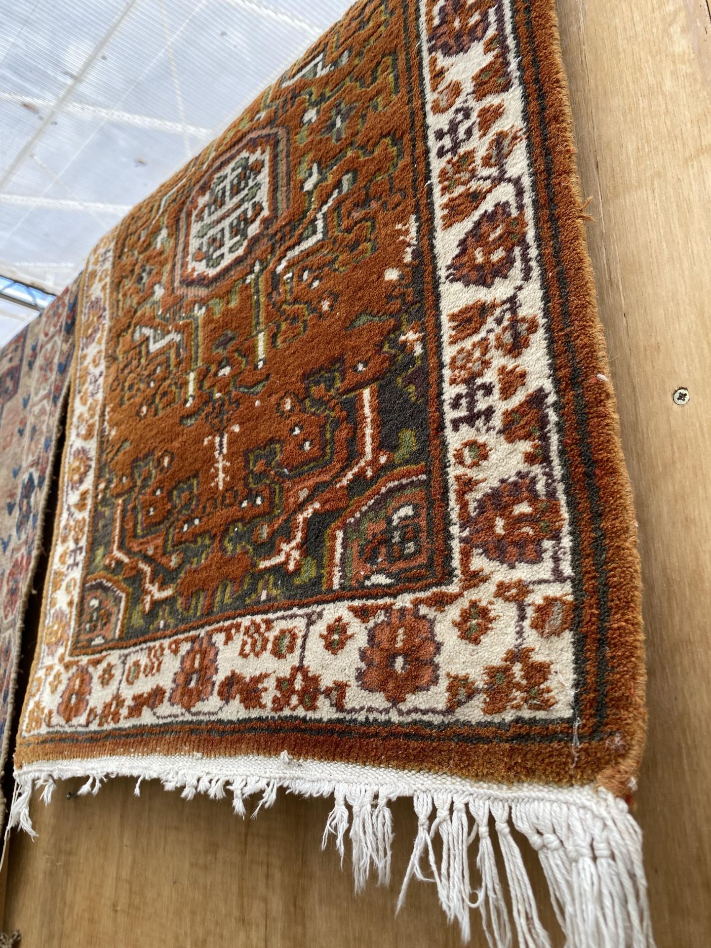 A VINTAGE FRINGED PATTERNED RUG AND A SMALL ORANGE PATTERNED FRINGED RUG - Image 2 of 3