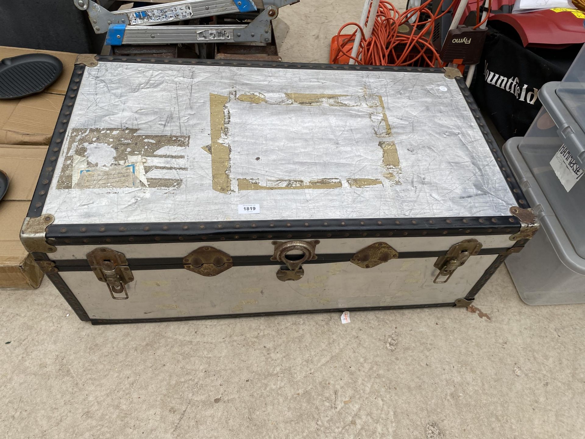 A LARGE HARD CASED TRAVEL TRUNK