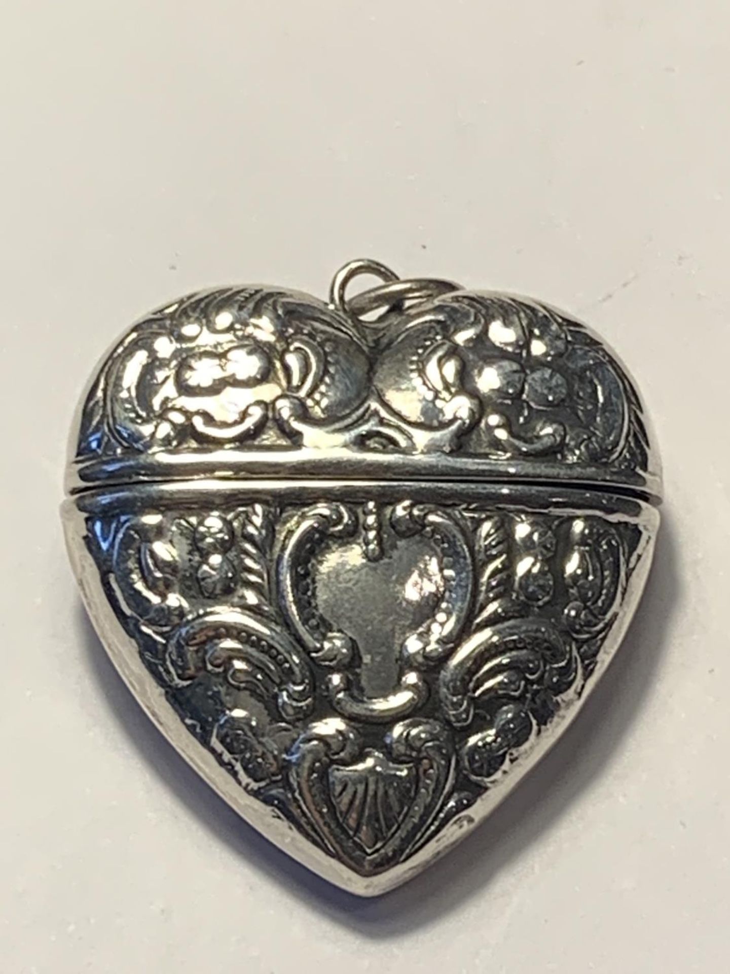 A MARKED SILVER HEART SHAPED CASE