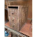 A VINTAGE WOODEN THREE DRAWER TOOL CHEST CONTAINING AN ASSORTMENT OF HARDWARE