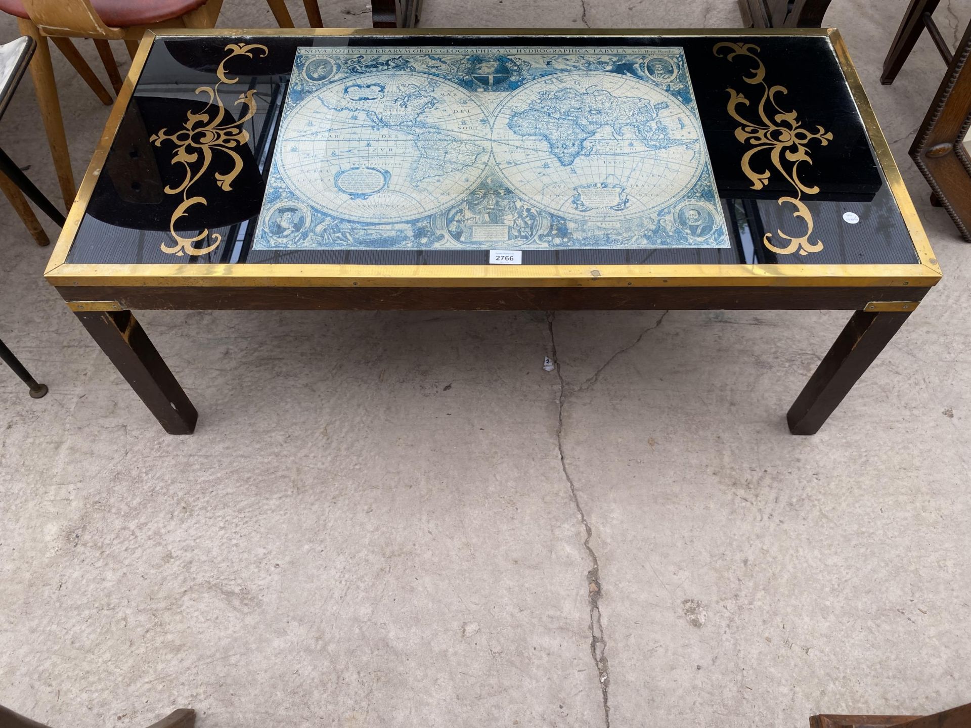 A COFFEE TABLE WITH BRASS TRIM ENCLOSING VINTAGE STYLE WORLD MAP 41" x 19"