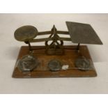 A SET OF BRASS AND WOOD POST OFFICE SCALES WITH WEIGHTS