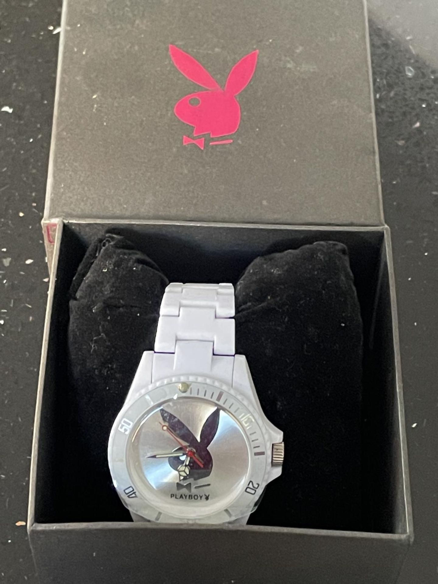 A PLAYBOY WRIST WATCH WITH WHITE STRAP IN A PRESENTATION BOX SEEN WORKING BUT NO WARRANTY