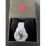 A PLAYBOY WRIST WATCH WITH WHITE STRAP IN A PRESENTATION BOX SEEN WORKING BUT NO WARRANTY