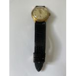 A 1960'S JUNGHANS 16 JEWEL WRIST WATCH WITH SUB DIAL AND BLACK LEATHER STRAP. SEEN WORKING BUT NO