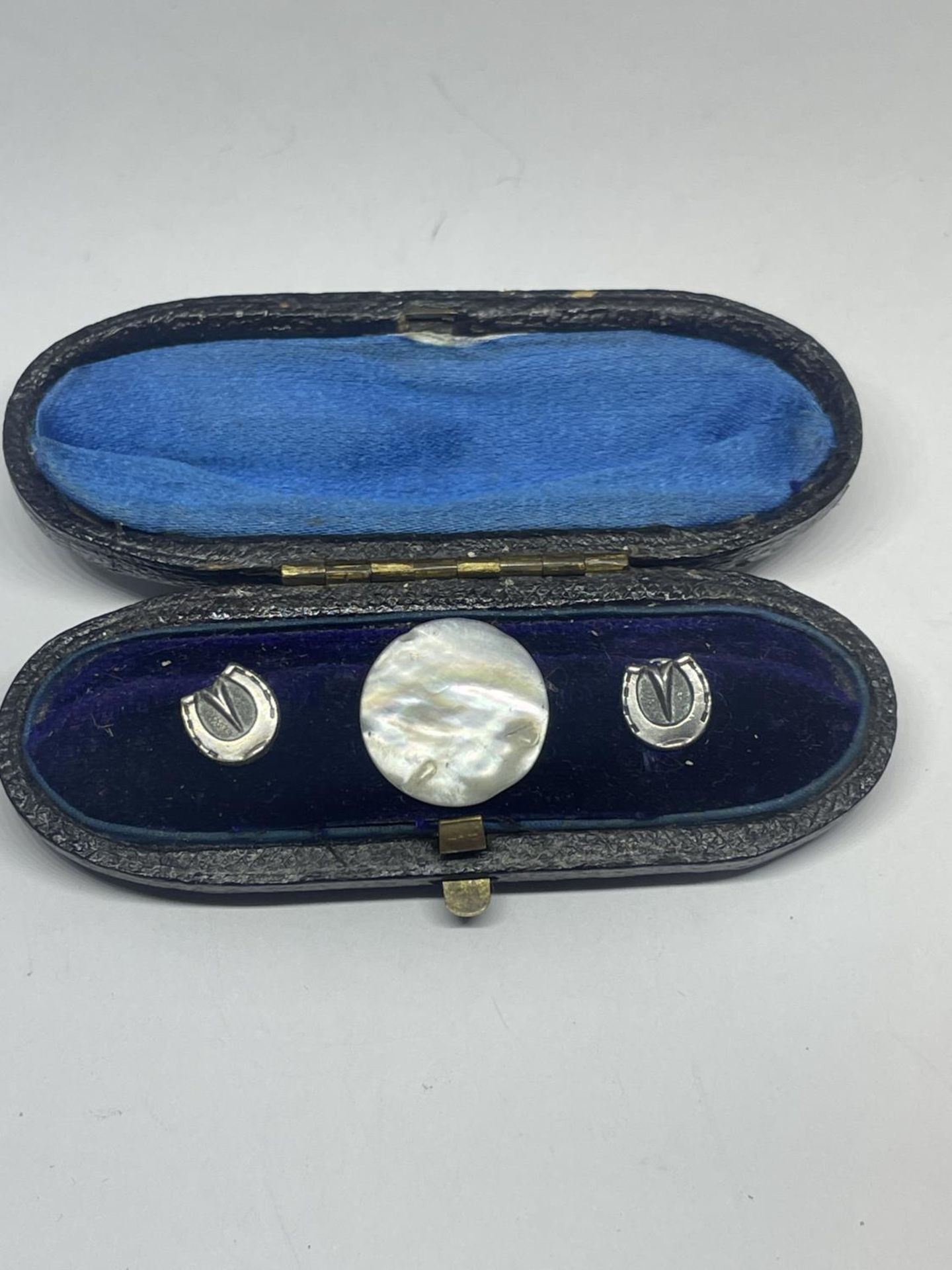 A VINTAGE BOXED SET OF THREE COLLAR STUDS - TWO HORSESHOES AND ONE MOTHER OF PEARL