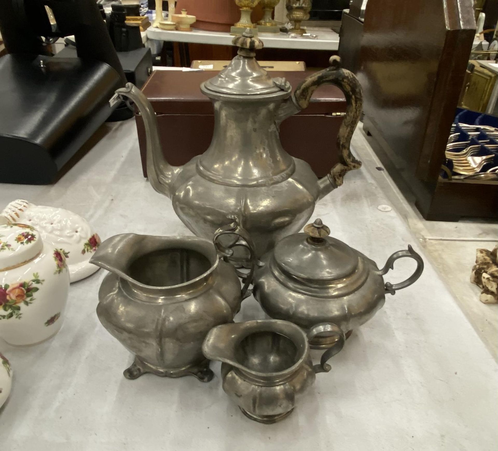A PEWTER TEASET TO INCLUDE TEAPOT, SUGAR, MILK AND HOT WATER JUG