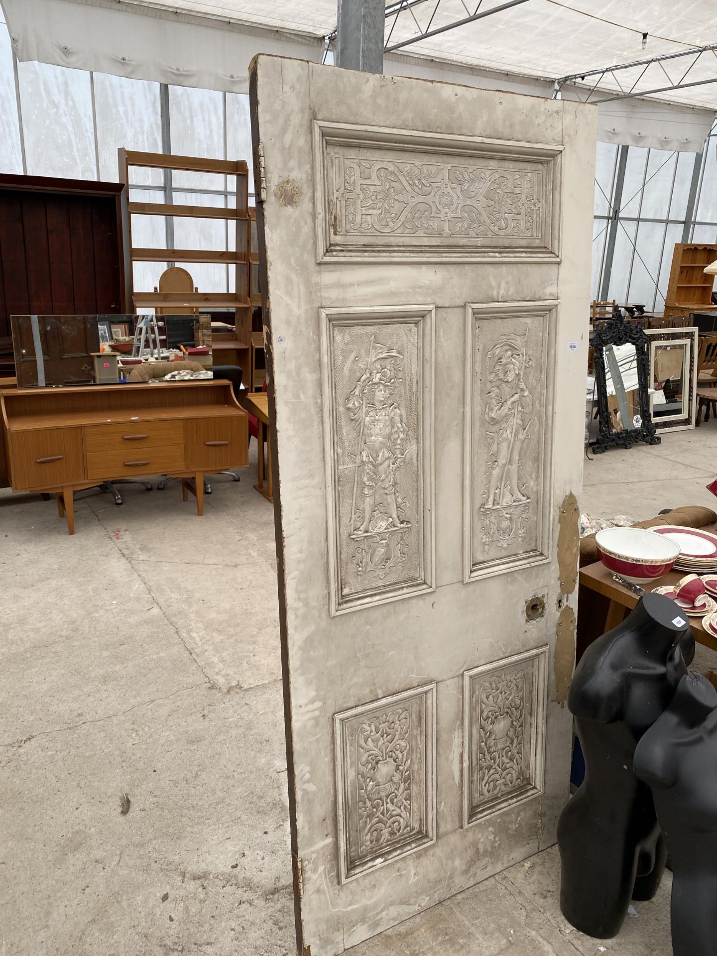 A VINTAGE SCRUMBLE PINE EXTERNAL DOOR WITH DECORATIVE PANELS