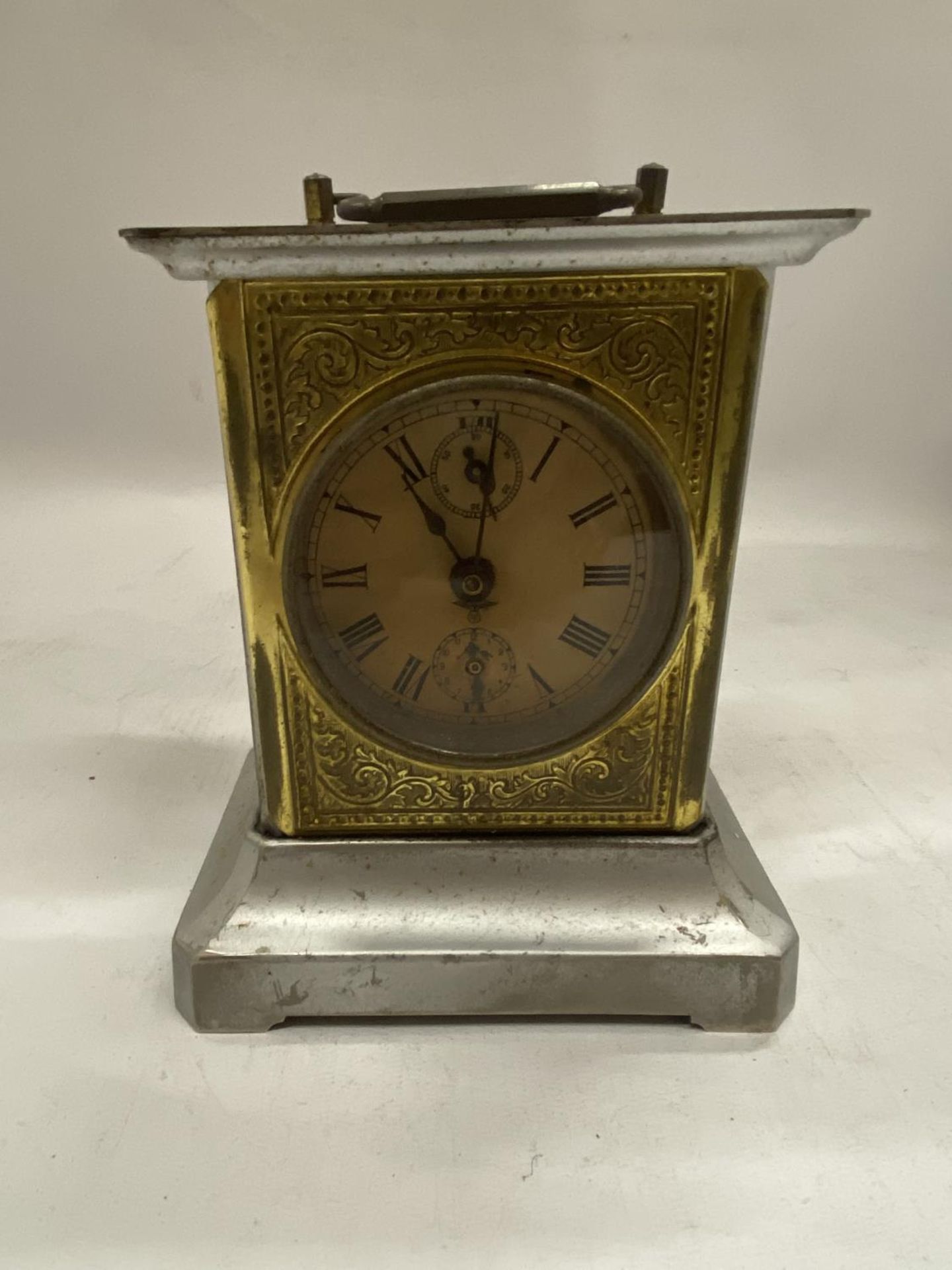 A VINTAGE BRASS AND METAL MANTLE CLOCK