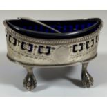 A GEORGE III SILVER OPEN SALT ON BALL AND CLAW FEET WITH BLUE GLASS LINER AND LATER HALLMARKED