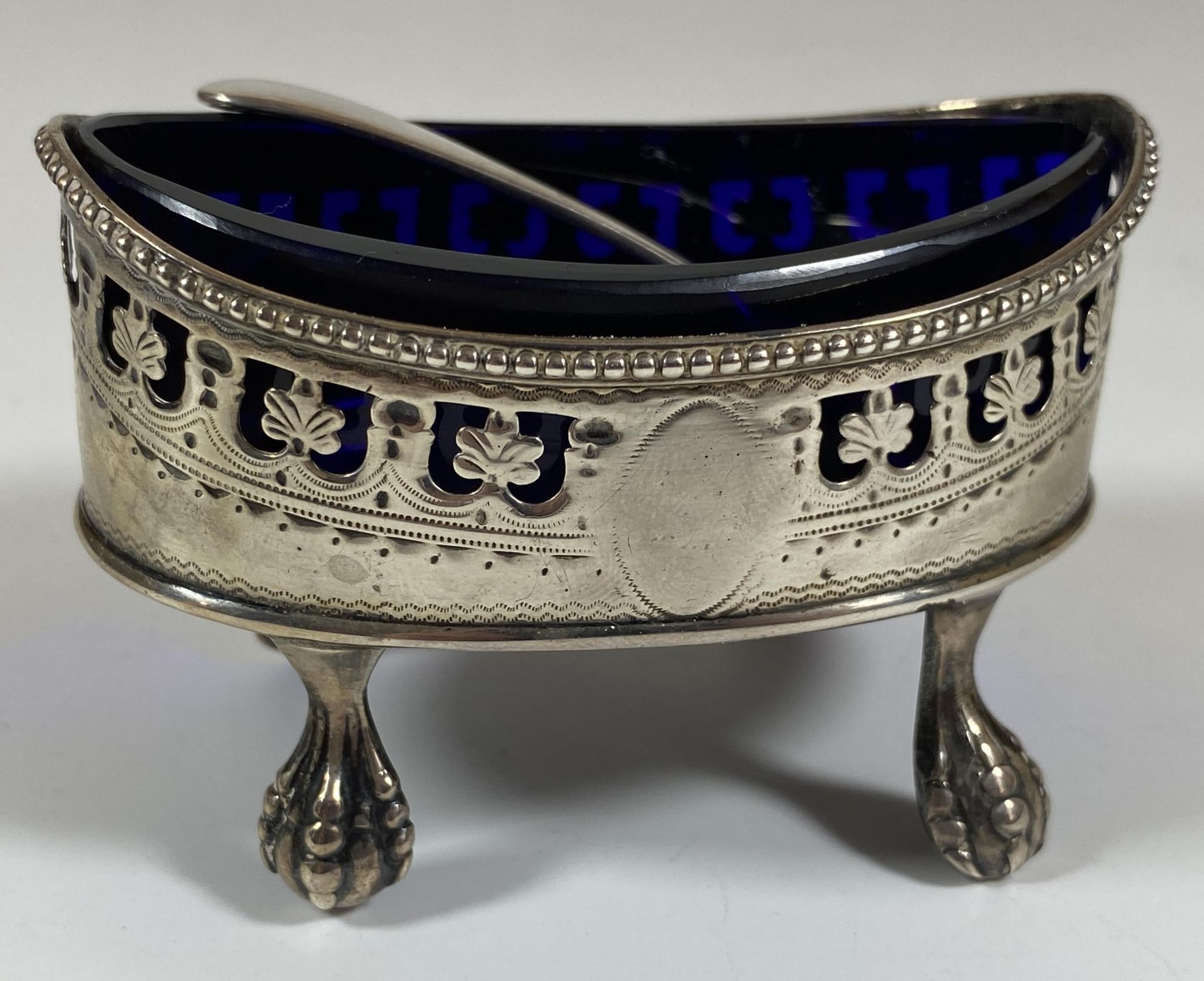 A GEORGE III SILVER OPEN SALT ON BALL AND CLAW FEET WITH BLUE GLASS LINER AND LATER HALLMARKED