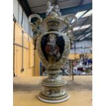 A VERY LARGE ITALIAN CERAMIC URN WITH PEDESTAL BASE AND LID, ORNATELY DECORATED WITH A PAINTING OF A