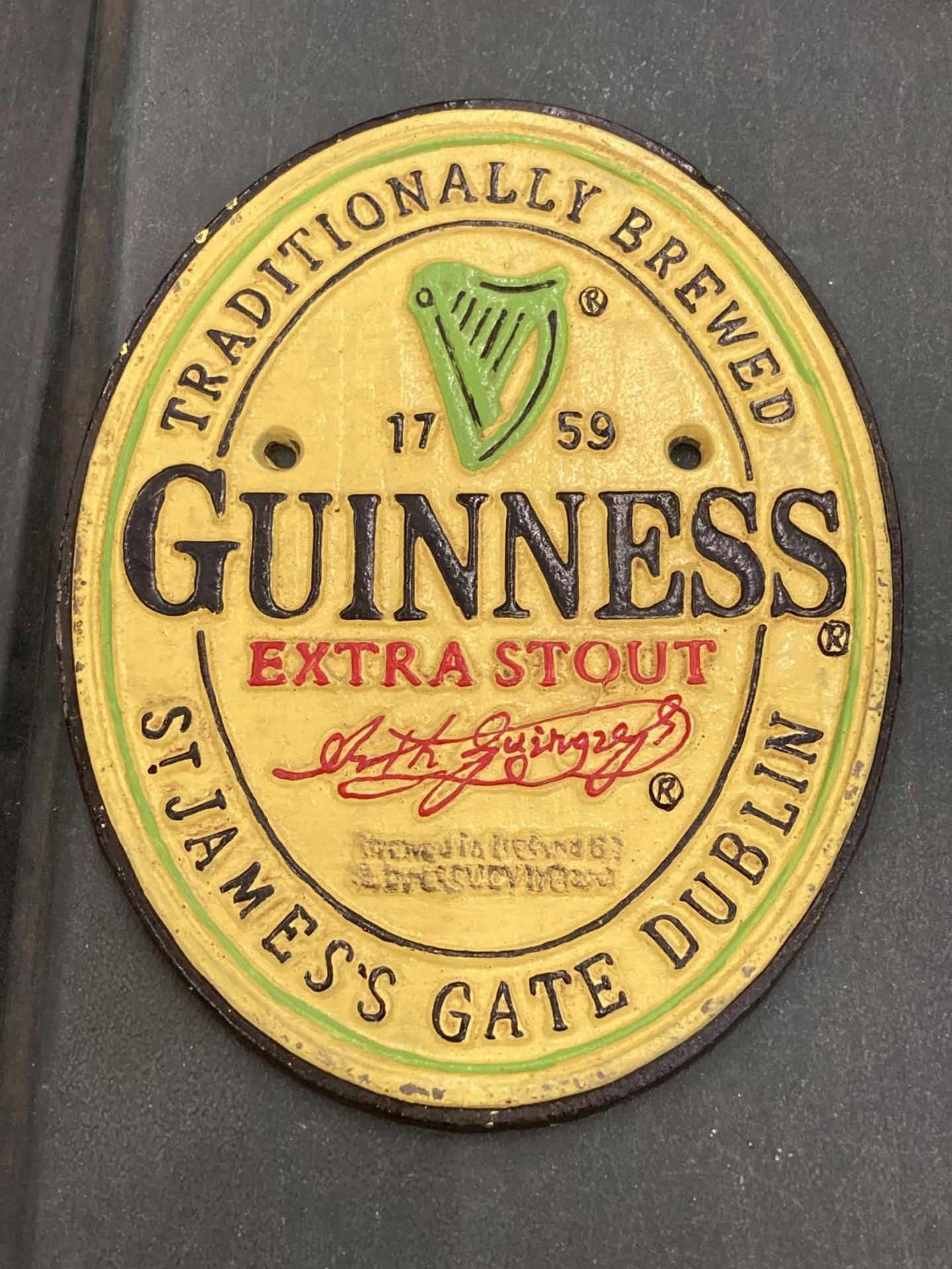 A CAST GUINNESS SIGN 15CM X 20CM