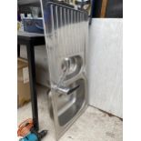 A STAINLESS STEEL SINK UNIT WITH TAP