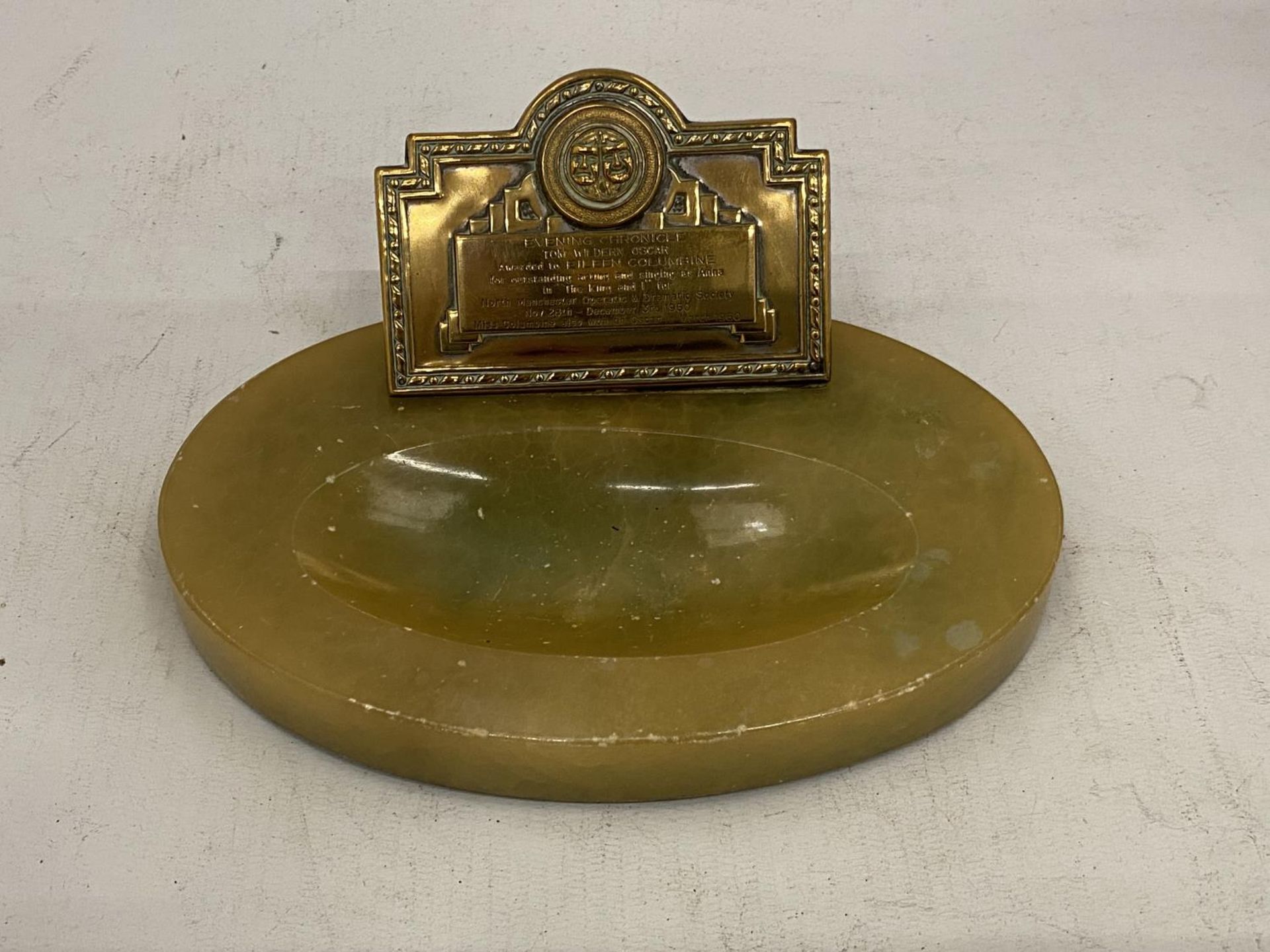 AN ONYX ASHTRAY WITH A BRASS PLAQUE ' EVENING CHRONICLE AWARD'