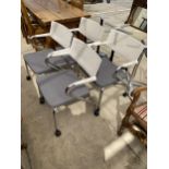 A SET OF FOUR VITRA GREY AND CREAM MEETING CHAIRS ON TUBULAR CHROME FRAMES AND CASTERS