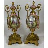 A PAIR OF FRENCH 19TH CENTURY, POSSIBLY SEVRES, PINK PORCELAIN AND BRASS GARNITURE VASES WITH HAND