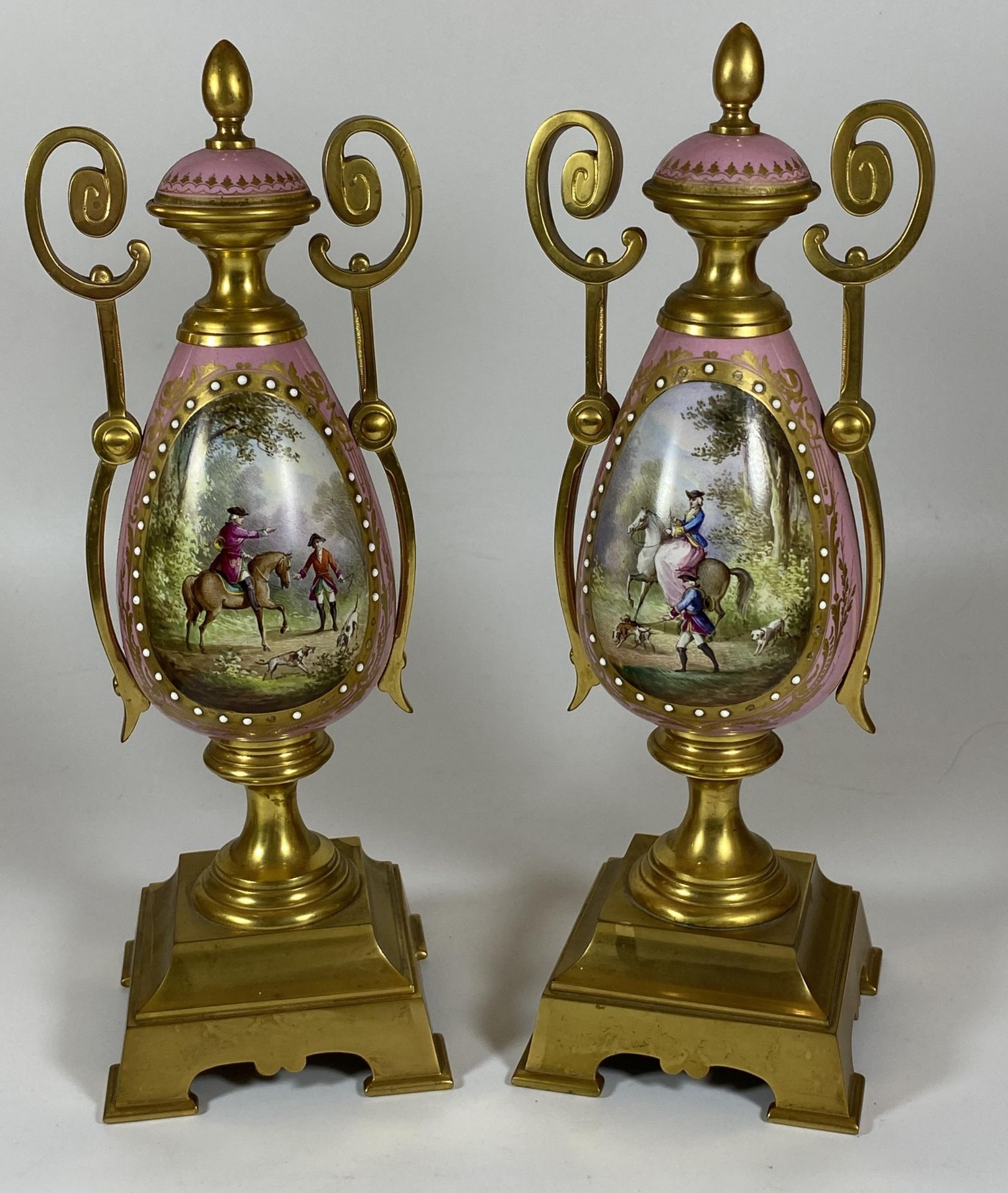 A PAIR OF FRENCH 19TH CENTURY, POSSIBLY SEVRES, PINK PORCELAIN AND BRASS GARNITURE VASES WITH HAND