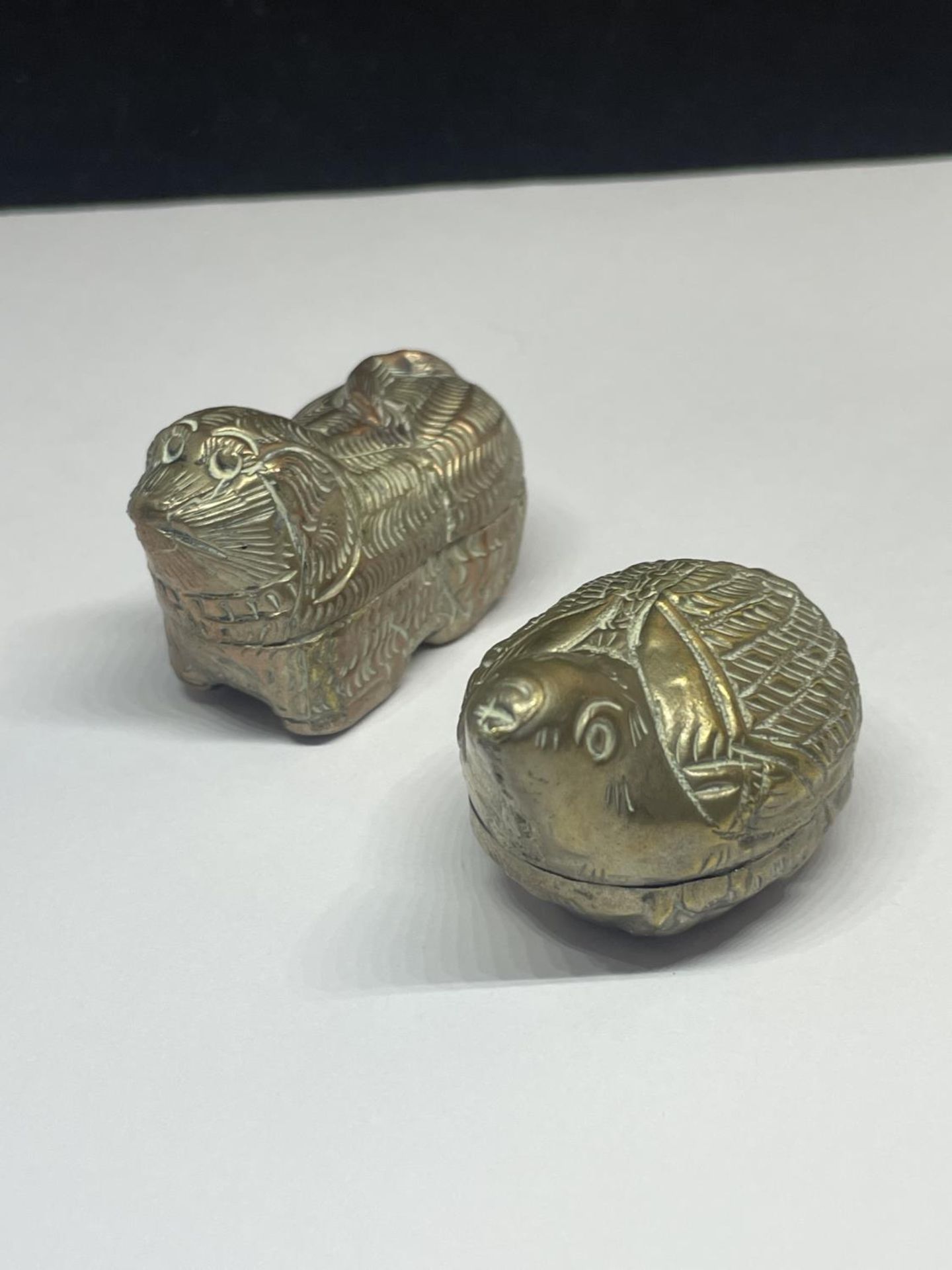 TWO WHITE METAL LIDDED POTS IN THE FORM OF ANIMALS