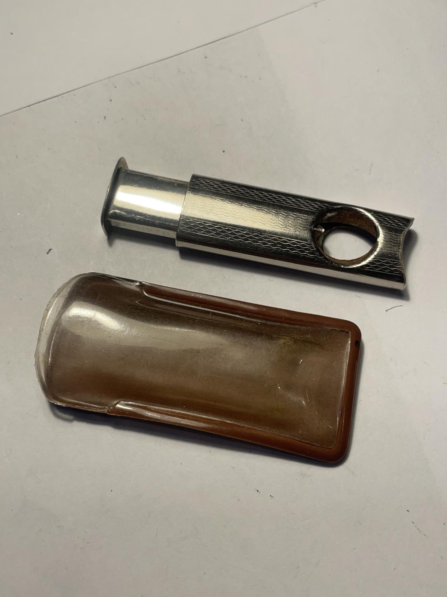 A VINTAGE CIGAR CUTTER WITH CASE