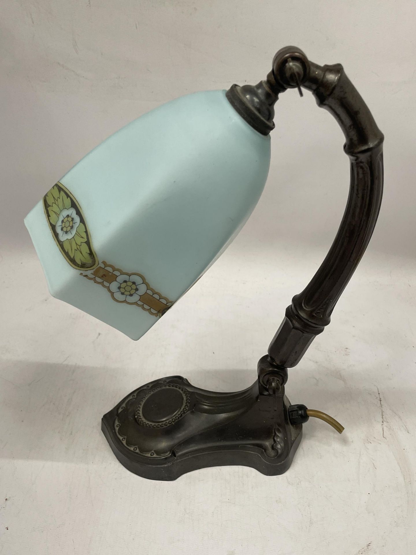 AN ART NOUVEAU METAL TABLE LAMP WITH FROSTED GLASS SHADE