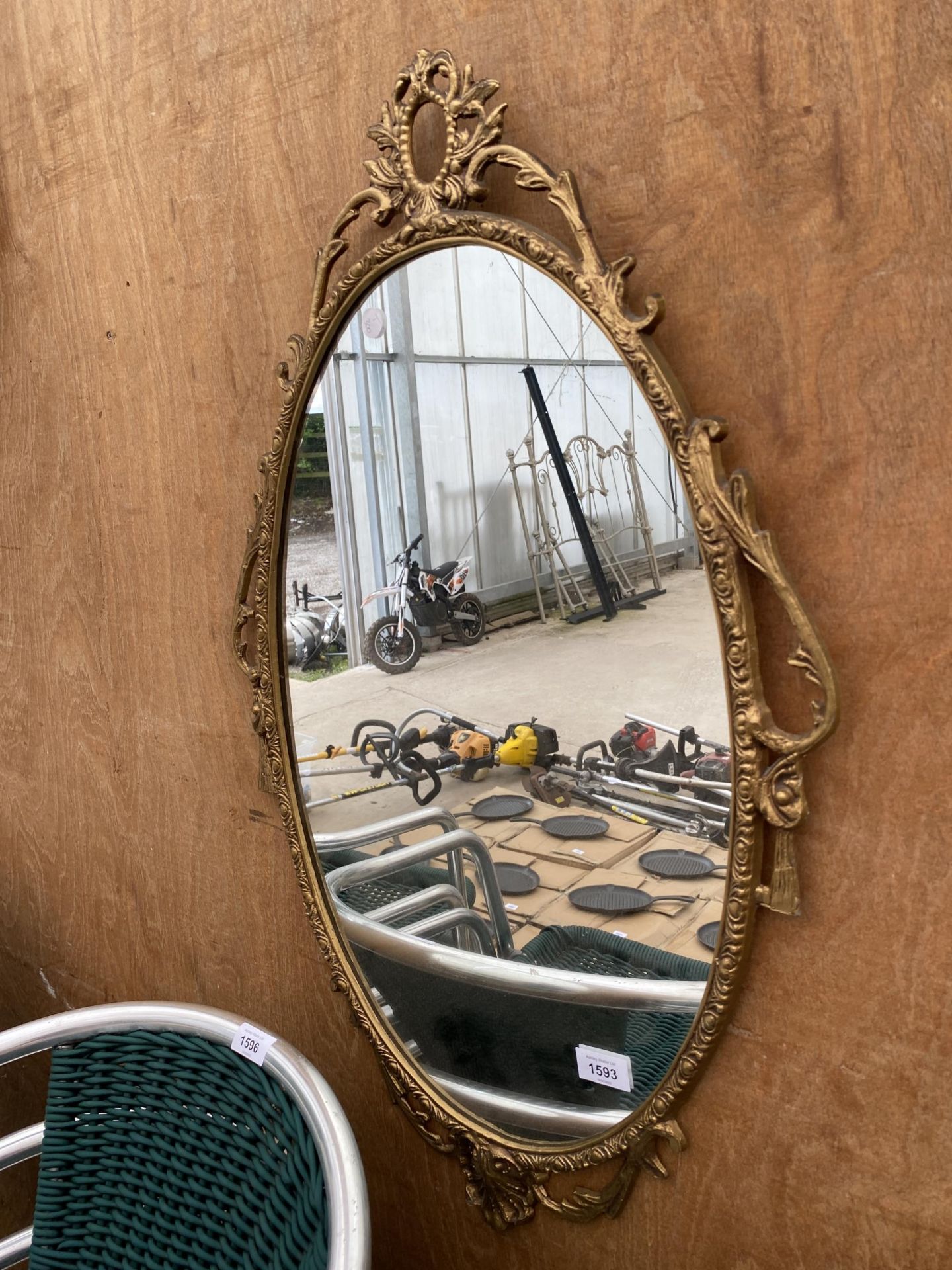 A DECORATIVE BRASS FRAMED WALL MIRROR