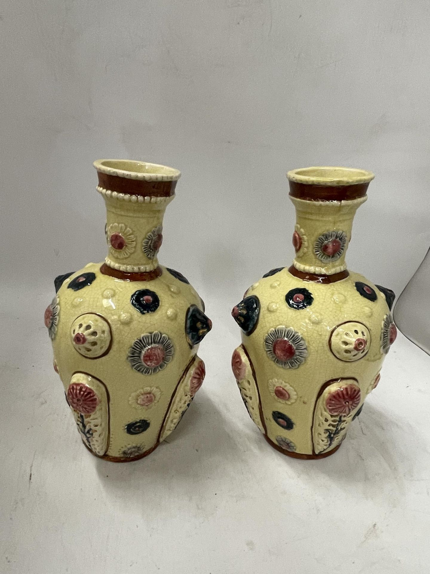 A PAIR OF CONTINENTAL PORCELAIN VASES IN THE ZSOLNAY PECS STYLE, UNMARKED