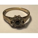 A 9 CARAT GOLD RING WITH A CENTRE SAPPHIRE SURROUNDED BY CUBIC ZIRCONIAS IN A FLOWER DESIGN SIZE N/0