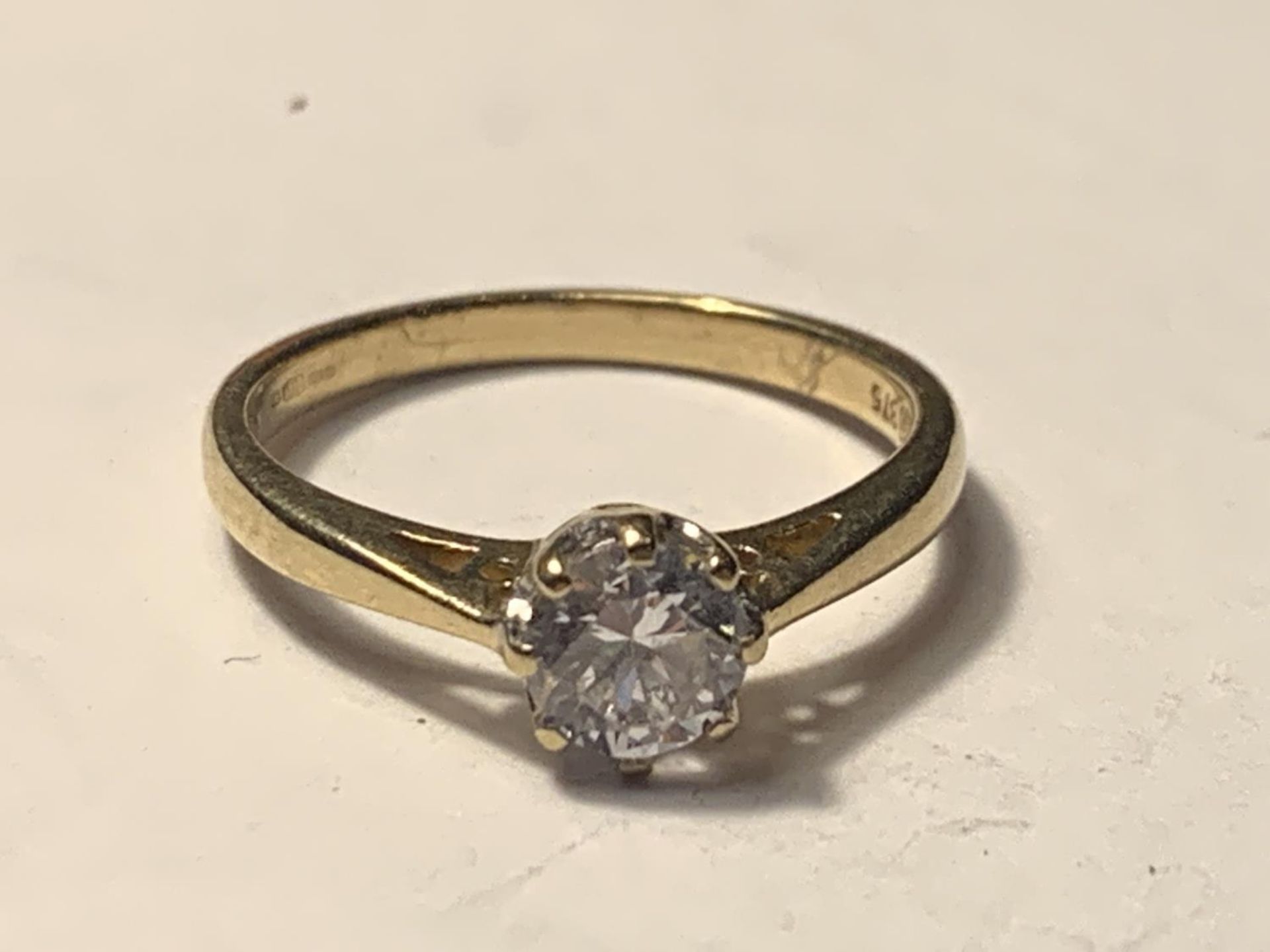 A 9 CARAT GOLD RING WITH A SOLITAIRE CUBIC ZIRCONIA SIZE J/K