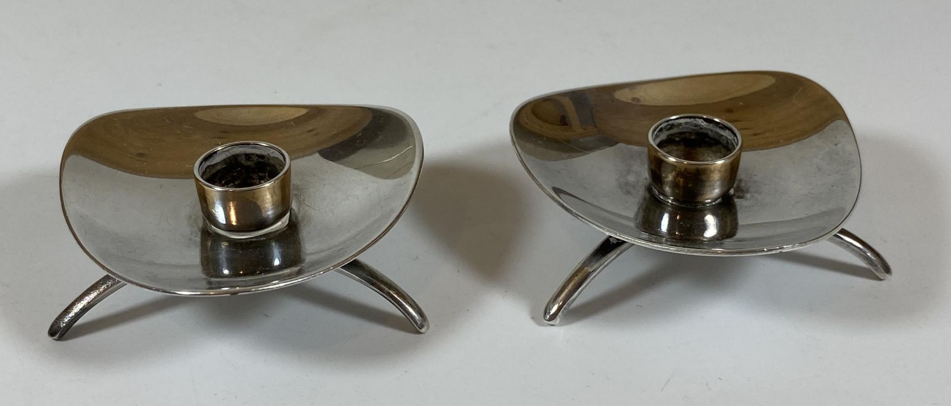 A PAIR OF ATLA DANISH SILVER PLATED SMALL CANDLE HOLDERS